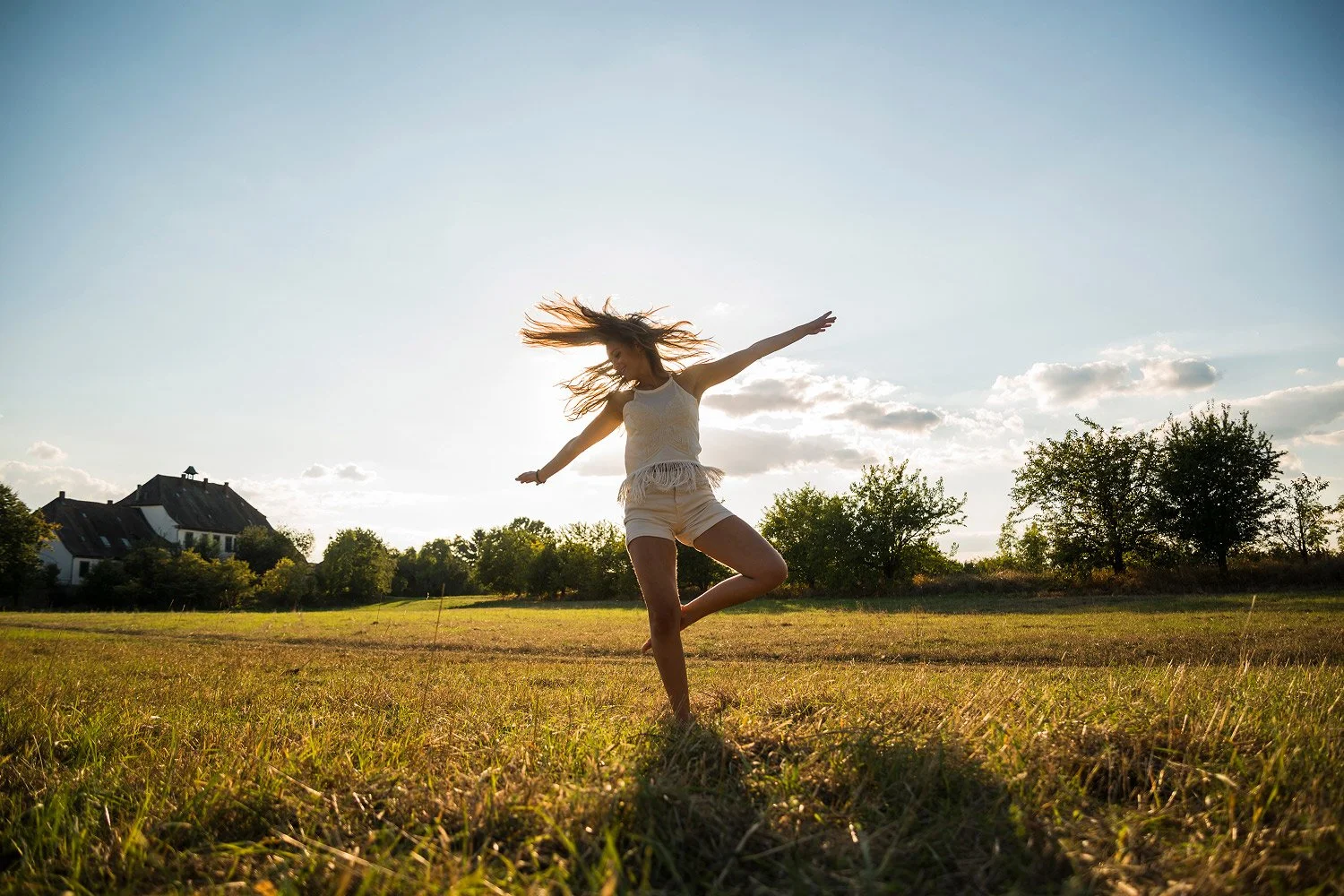 Person practicing gentle movement transitions in a calm environment